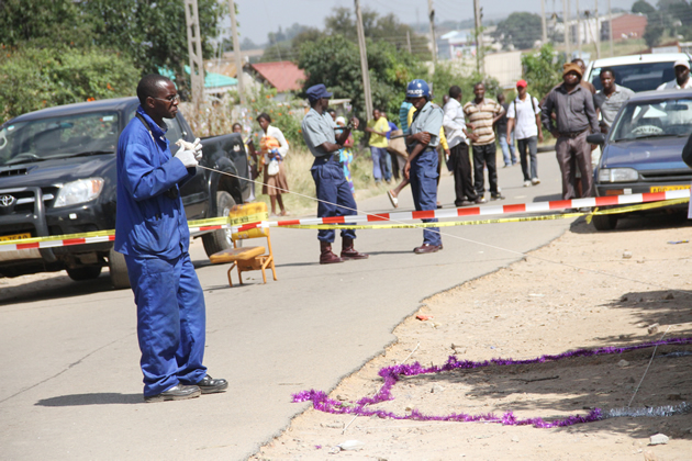 Members of CID removing markings from where the body of Moses Mutepfa was in Sunningdale where the blast occured