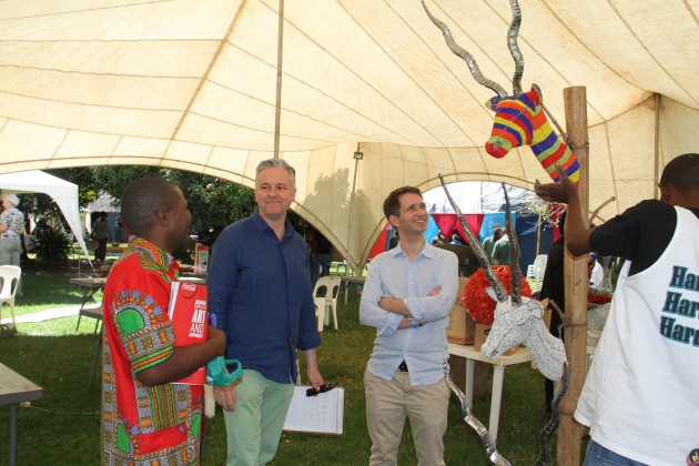Mr Joseph Padzareverwa (left) explaining his artwork to HIFA Manager Manuel Bagoro (2nd left) while Sebastian Enser-wight look on yesterday