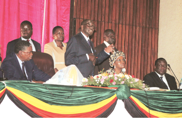 President Mugabe delivers a speech after appointing his deputies Cdes Emmerson Mnangagwa (extreme right) and Phelekezela Mphoko (left) at zanu-pf Headquarters in Harare yesterday as the First Lady and Women’s Affairs secretary Dr Grace Mugabe listens