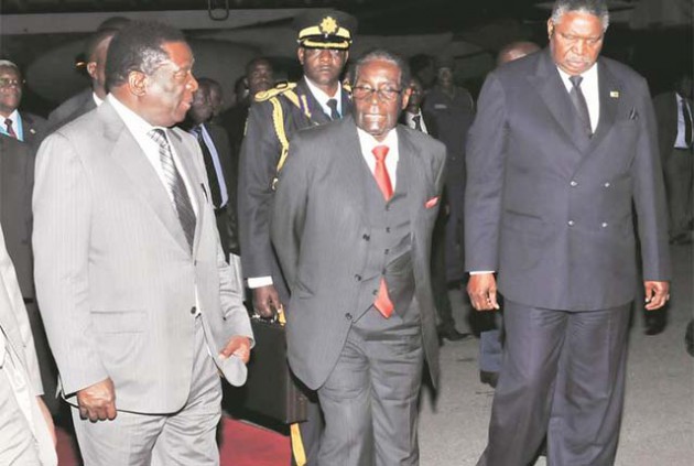 President Mugabe talks to Vice Presidents Cdes Emmerson Mnangagwa and Phelekezela Mphoko on arrival at Harare International Airport from Gaborone, Botswana, where he attended the Sadc Double Troika Summit on Lesotho. — (Picture by Presidential Photographer Joseph Nyadzayo)