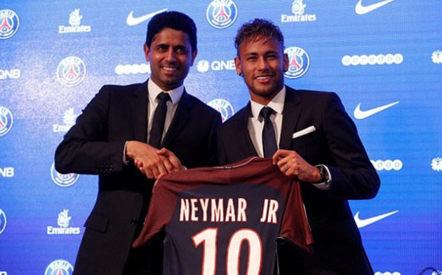 A BOLD MOVE . . . Brazilian soccer star Neymar (right) shakes hands with PSG’s Qatari chairman Nasser Al-Khelaifi at his presentation in Paris yesterday after his shock move to the French League 1 side which shook the whole footballing world this week