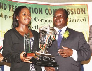 NUMERO UNO . . . Rising tennis star Nicole Dzenga (left) receives the Sportsperson of the Year trophy, on behalf of winner and tennis ace Cara Black, from Sport, Arts and Culture Minister Andrew Langa in Harare on Wednesday  night