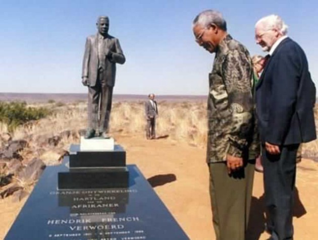 Former South African president Nelson Mandela pays his respects at the grave of Hendrik Verwoerd, the man who condemned him to 27 years in prison. With him is  the man behind Orania,  Carel Boshoff
