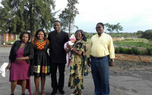 Minister Nyoni (holding a baby) and her husband (right) pose for a photo with (from left) Sandra Ndebele, Minister Nyoni’s niece Patience and her Nigerian husband
