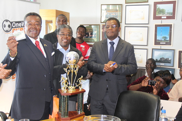 BIG CUP, BIG MONEY . . . Information and Communication Technology and Postal and Courier Services Minister Webster Shamu (left), the guest of honour, joins NetOne managing director Reward Kangai (right) and PSL vice chairman Peter Dube in unveiling the trophy during the launch of the One Wallet Cup tournament in Harare yesterday
