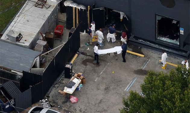 Investigators work at the scene following a mass shooting at the Pulse gay nightclub in Orlando Florida, US, on Sunday. — Daily Mail