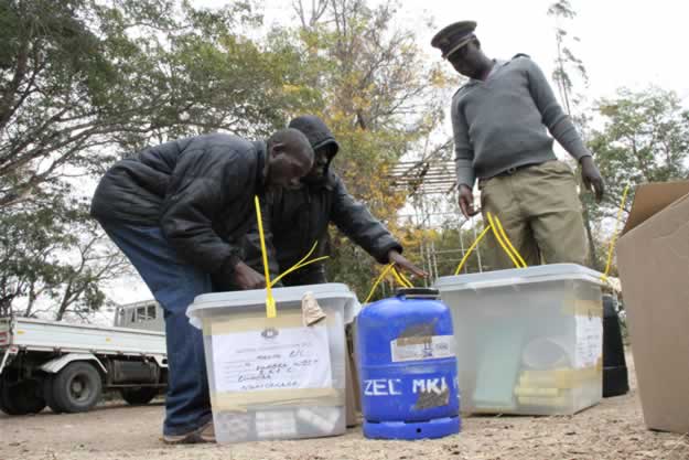 Officials and a plocice officer arrive at Buhera West command center with ballot boxes and other materials used during elections1