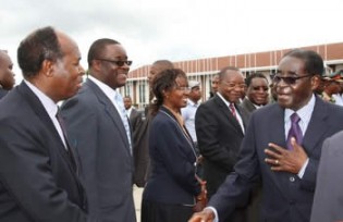 President Mugabe, who was leaving for Singapore, bids farewell to Deputy Chief Secretary to the President and Cabinet Retired Colonel Christian Katsande, while Presidential spokesman Mr George Charamba, director of Protocol Ruth Chikwira and principal director in the Ministry of Information Mr Regis Chikowore look on at the Harare International Airport yesterday. —