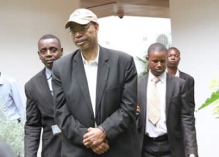 Former US Congressman Melvin Jay Reynolds (in cap) after he was arrested by immigration officials and CID officers at Bronte Garden Hotel in Harare yesterday. — (Picture By Justin Mutenda)