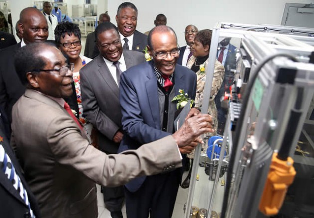 President Mugabe is shown how to operate the hot stamping machine by Registrar-General Tobaiwa Mudede at the official opening of the National Passport Production Centre in Harare yesterday. Looking on are Vice Presidents Emmerson Mnangagwa and Phelekezela Mphoko and Harare Provincial Affairs Minister Miriam Chikukwa. — Picture by Chief Photographer Believe Nyakudjara