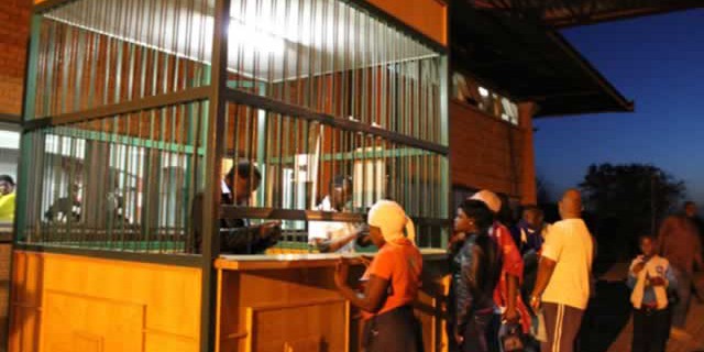 Health officials inspect passports at the Port Health Station at Plumtree Border Post yesterday