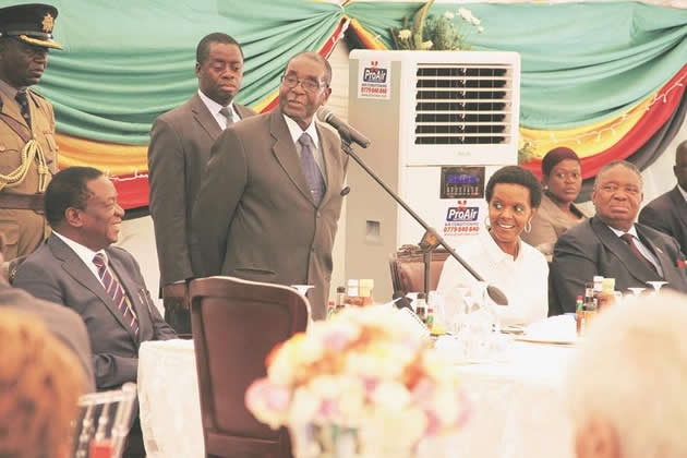 President Mugabe addresses guests while flanked by First Lady Amai Grace Mugabe and Vice Presidents Emmerson Mnangagwa and Phelekezela Mphoko (right) at a Christmas party he hosted at State House in Harare yesterday. — (Picture by Tawanda Mudimu)