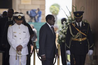 President Mugabe arrives to bid farewell to South Africa’s former president Nelson Mandela lying in state at the Union Buildings in Pretoria yesterday. Nelson Mandela’s flag-draped casket made a solemn journey through the streets of Pretoria yesterday, arriving at the seat of South Africa’s government where he will lie in state for three days. — AFP