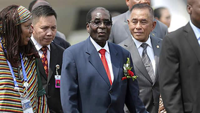 President Mugabe, accompanied by Indonesian Defence Minister Ryamizard Ryacudu (second from right) and other dignitaries on arrival at Halim Perdanakusuma Airport in Jakarta, Indonesia, yesterday. —AP