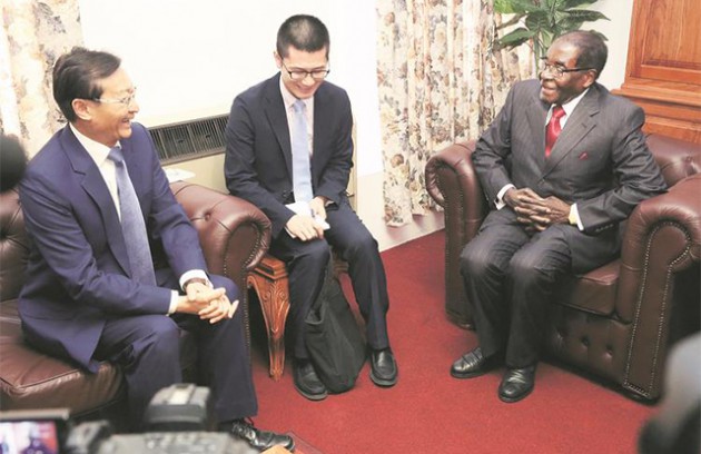 President Mugabe shares a lighter moment with Chinese Vice Foreign Affairs Minister Zhang Ming (far left) at his Munhumutapa offices in Harare yesterday. — (Picture by Believe Nyakudjara)