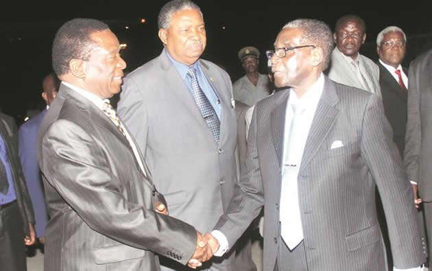 President Mugabe bids farewell to Vice Presidents Emmerson Mnangagwa and Phelekezela Mphoko prior to his departure for India last night, while ministers Kembo Mohadi and Ignatius Chombo look on. — (Picture by Munyaradzi Chamalimba)