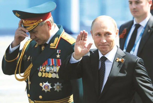 Top: Russian President Vladimir Putin and a general salute the crowd, while members of the security forces go through their drills