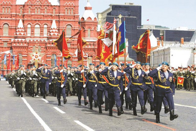 while members of the security forces go through their drills