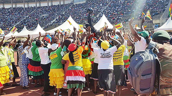 The only female paratrooper who flew today, Flight Sergeant Munodawafa being lifted by members of the Mbare Chimurenga Choir.