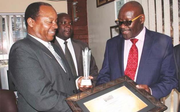 Health and Child Care Minister Dr David Parirenyatwa looks at the awards given to Chitungwiza Central Hospital CEO Dr Obadiah Moyo during his tour of the hospital yesterday. Looking on is Mr Gideon Mapokotera. — (Picture by John Manzongo)