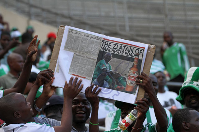 Passionate fans-CAPS United fans lift up a Leonard Tsipa story from The Herald newspaper