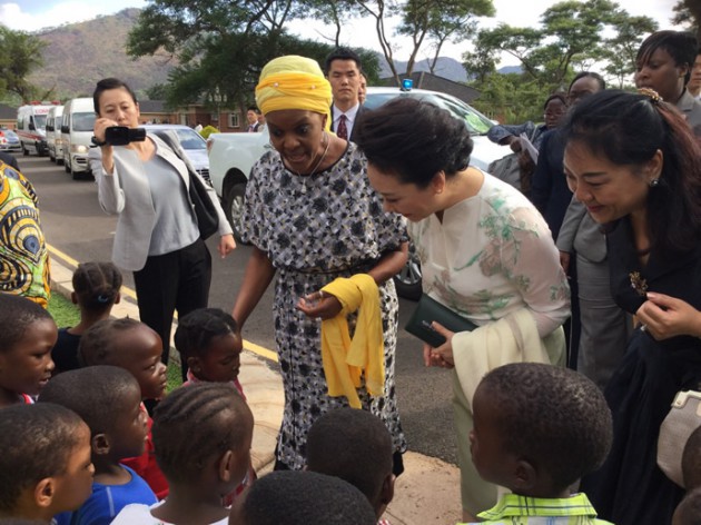 First Lady Amai Grace Mugabe and Chinese First Lady Peng Liyuan chat to children at Mazowe Children's home