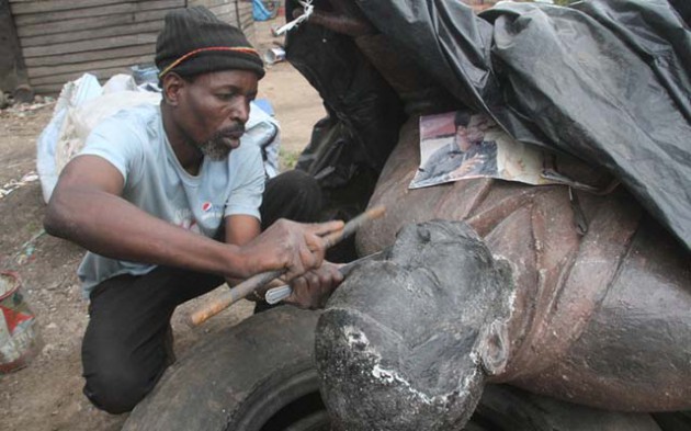 Petros Ndlovu works on a life-size statue at his “workshop” along the Mukuvisi River banks