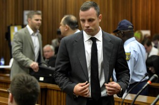 South African amputee Olympian sprinter Oscar Pistorius arrives at the High Court in Pretoria on March 3, 2014 on the opening day of his murder trial, accused of murdering his girlfriend Reeva Steenkamp. – AFP.