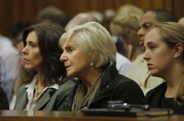 Relatives of South African Paralympic athlete Oscar Pistorius attend his ongoing murder trial on March 11, 2014 in Pretoria. – AFP.