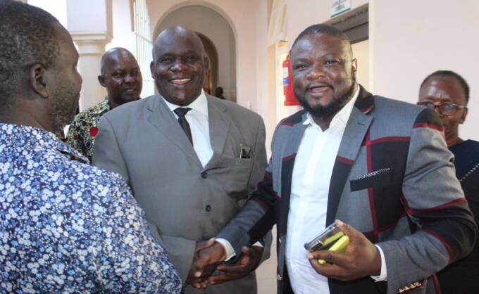 Sitting legislator for Chipinge South Constituency, Cde Enock Porusingazi (centre) shakes hands with his opponent in the August 23 polls, CCC candidate Mr Clifford Sahlayo (right) at the Nomination Court on Wednesday: Pictures —  Tinai Nyadzayo