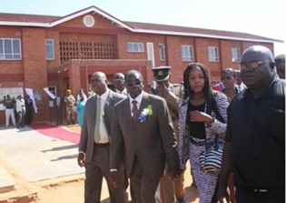 President Mugabe accompanied by his daughter Bona and Principal and Head of Chishawasha Mission Father Fidelis Mukonori after commissioning a hostel block and computer lab at the institution in Goromonzi yesterday.
