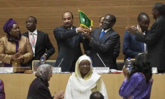 African Union chairman President Mugabe receives the instruments of office from his predecessor Mr Mohamed Ould Abdel Aziz of Mauritania soon after assuming leadership of the bloc during the official opening of the 24th Ordinary Session of the AU General Assembly in Addis Ababa, Ethiopia, yesterday. Looking on is AU Commission chair Dr Nkosazana Dlamini Zuma and AU Commissioners. — AFP