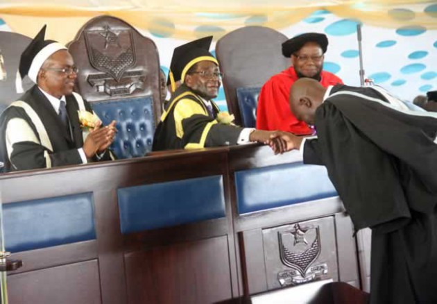 The Chancellor of Bundura University of Science Education President Mugabe congratulates Lovemore Manyeruke, who graduated with a First Class Bachelor of Science Education Honours Degree , while Vice Chancellor Professor Eddie Mwenje (left) and Primary and Secondary Education Minister Dr Lazarus Dokora look on, in Bindura yesterday. — (Picture by Munyaradzi Chamalimba)