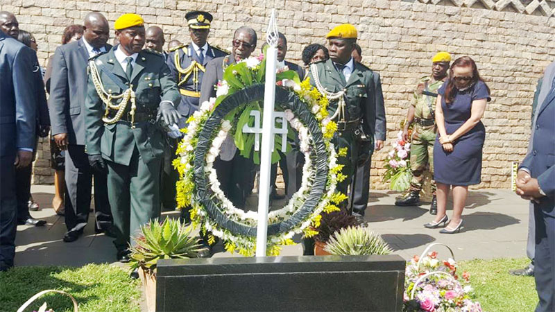 President Mugabe at the grave of his late sister Sabina Mugabe who is also mother to Youth Empowement Minister Cde Patrick Zhuwao.