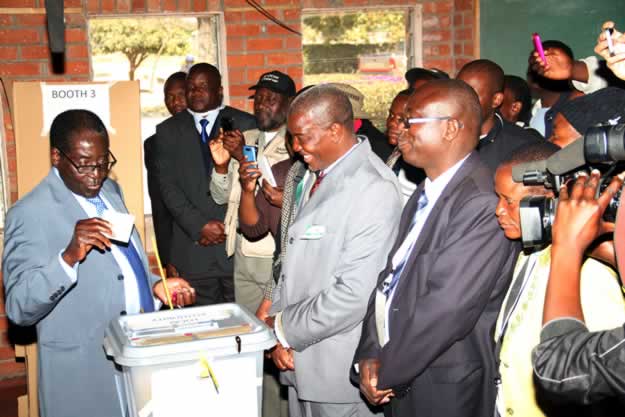 President Mugabe casts his vote while observers and political party agents watch at Mhofu Primary School polling station in Highfields