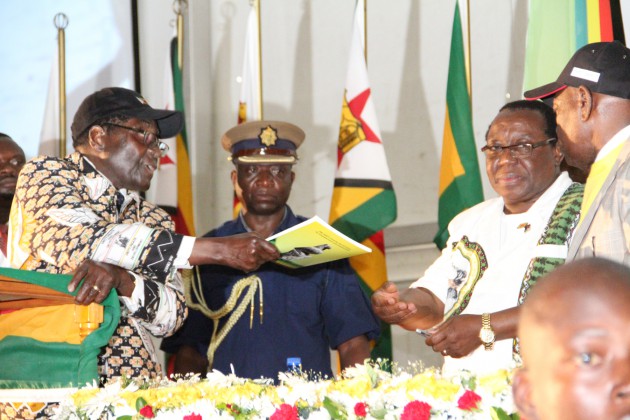 President Mugabe hands over thje Central Committee Report to Cde Simon Khaya Moyo and Cde Didymus Mutasa