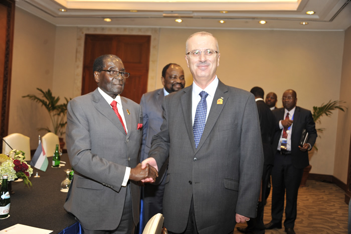 President Mugabe meets Palestinian President Mahmoud Abbass representative at the Jakarta Convention Centre this morning.