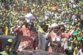 President Mugabe and First Lady Amai Grace Mugabe wave to supporters at a rally