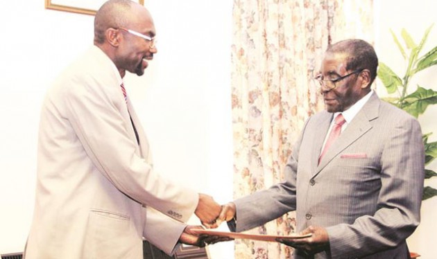 President Mugabe receives a document from Republic of Gambia Minister of Environment, Climate change , Water, Forestry and Wildlife Pa Ousman Jarju at his Munhumutapa Offices in Harare yesterday. — (Picture by Innocent Makawa)