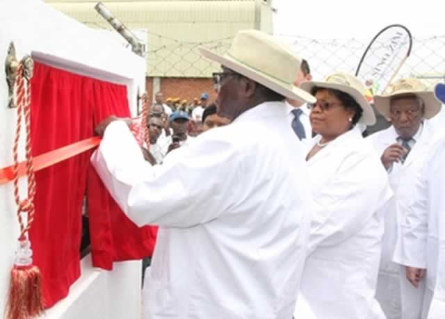 President Mugabe unveils a plaque at the Sino Zim Cotton Holdings ginnery, while Vice President Joice Mujuru looks on in Harare yesterday