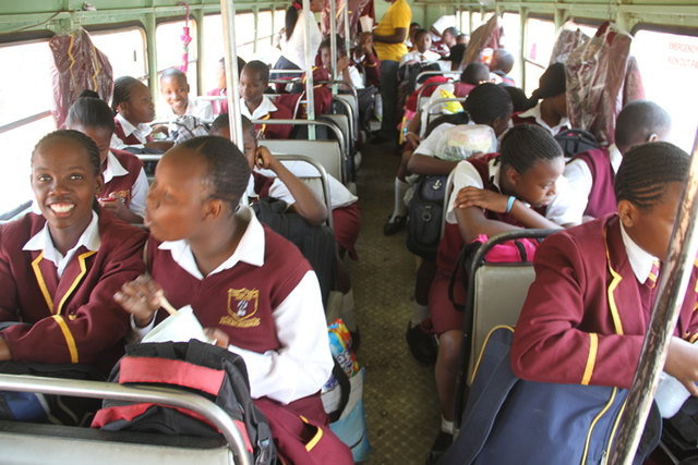Students from Langham Girls High School aboard a bus back to school
