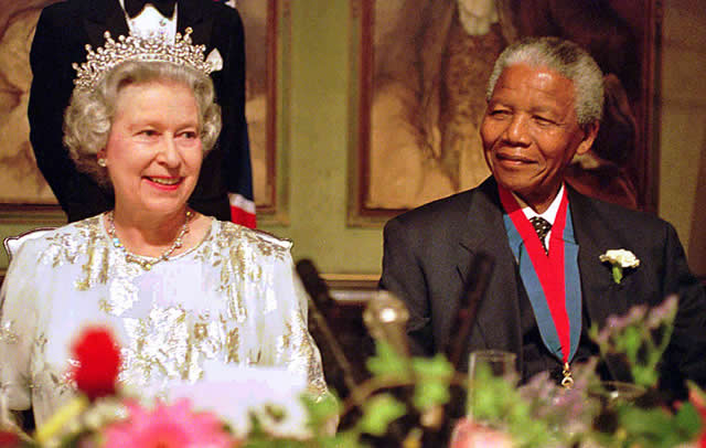 Nelson Mandela turned from the fiery anti-apartheid war hero into a darling of Westerners. In this file photo Queen Elizabeth II pays a state visit to South Africa in 1995, the first by a ruling British monarch since 1947
