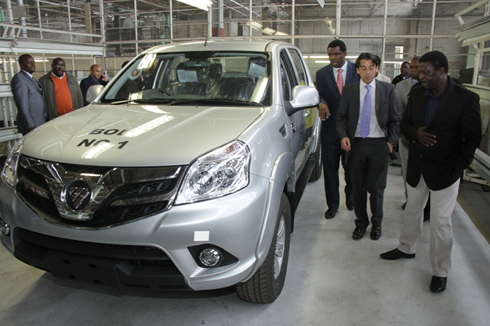 Quest Motors managing director Mr Tarik Adams takes Minister of Industry and Commerce Cde Mike Bimha and CZI national-vice chairman Mr Henry Nemaire on an inspection of a Foton Tunland that has just been assembled at the plant during the tour of some distressed companies in Mutare.