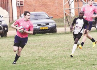 JUGGERNAUT . . . England Independent Schools’ Elliot Roofe goes for his first try under the challenge of Mbare Academy scrum-half Pride Nyameni at Harare Sports Club yesterday