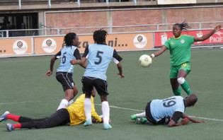 GOING FOR THE KILL...Mighty Warriors striker Rutendo Makore prepares to shoot through a wall of three Botswana defenders and their ‘keeper in an African Women Championship qualifier at Rufaro yesterday.