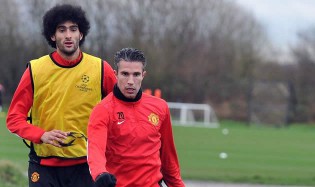 THE RED DEVILS . . . Manchester United striker Robin van Persie (right) and midfielder Marouane Fellaini take part in a training session at their Carrington complex in Manchester, north west England, yesterday ahead of the Uefa Champions League match against Olympiakos. — AFP
