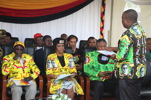 zanu-pf youth chair Kudzanayi Chipanga (standing, right) outlines the programme of events to President Mugabe, First Lady Amai Grace Mugabe and other dignitaries