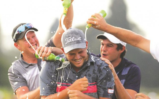 TO THE WINNER GOES THE SPOILS . . . Zimbabwe Open winner JC Ritchie is sprayed with champagne after his dramatic victory at Royal Harare yesterday. — Sunshine Tour