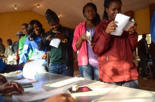 So-called "born free" voters wait to vote as part of the general elections yesterday at a polling station in Marikana, South Africa. - AFP