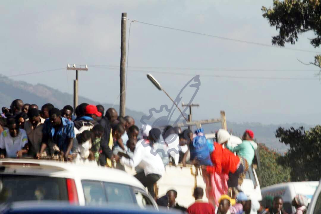 Those who have failed to make it into the stadium are watching over the pre-cast wall of the stadium.
